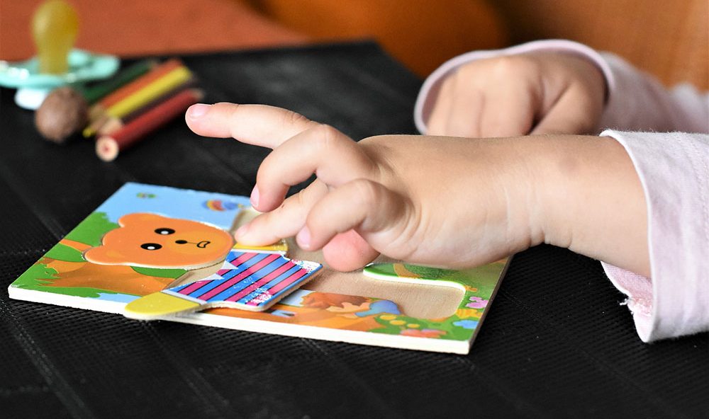 child working on a jigsaw puzzle